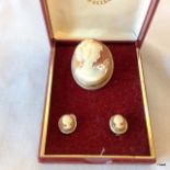 A silver cameo brooch and earrings