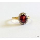 An 18ct gold diamond and garnet ring size J