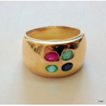 A yellow metal emerald, ruby and  sapphire ring