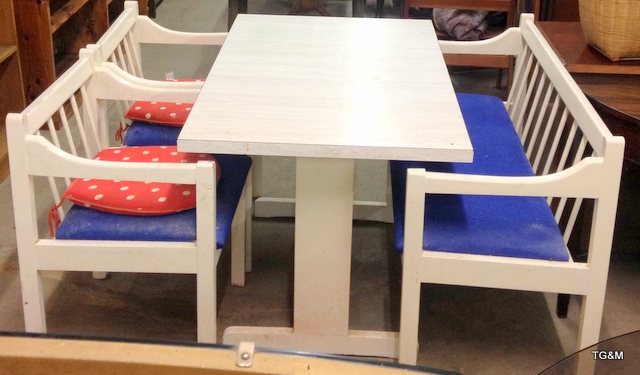 A white painted kitchen table with bench chair and 2 other chairs