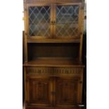 An old charm style linen fold dresser with lead glass to the cupboards