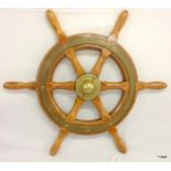 A brass and wood ships wheel 56cm