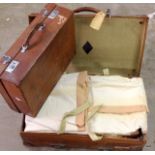 2 leather travelling suitcases 1 with a quantity of curtain material included large 66 x 44 and