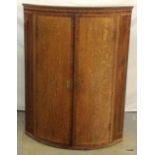 An Oak wall hanging corner cupboard with inlaid decoration 98 x 74cm