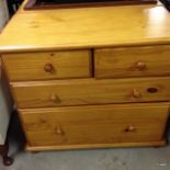 A pair of pine chest of drawers, only one shown