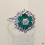 An 18ct white gold ring set with 1ct emeralds and 2ct  of diamonds