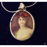 A silver and enamel necklace depicting a young lady