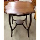 A mahogany pie crust lamp table on tapered legs