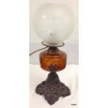 A wrought iron and glass converted oil lamp 50cm