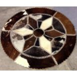 A native Indian cowhide rug 97cm in diameter