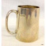 A silver drinks tankard