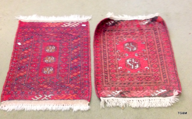 A pair of red pattered small hall carpets 75 x 52