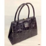 A ladies crocodile skin handbag