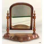 A mahogany bedroom mirror with jewellery compartment and bevelled glass