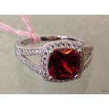 A silver CZ simulated ruby ring