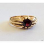 A 9ct gold mans signet ring with garnet stone size O