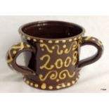 A Slipware 3 handled pottery mug 9cm high 11cm in diameter