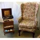 A sewing box, a wing back chair and crochet needles