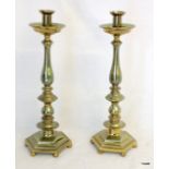 A pair of Victorian brass candle sticks