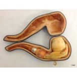 A meerschaum pipe with amber holder in original case