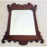 An Edwardian mahogany wall mirror. 88 x 52cm