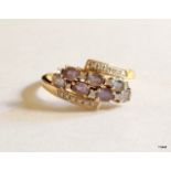 A 9ct gold amethyst and diamond cluster ring size U