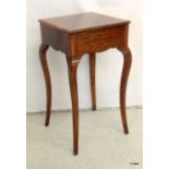 A walnut lamp table with cabriole legs and secret drawer