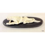 Early C20th ivory figure of crocodile fighting snake on a horn base