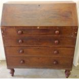 A mahogany bureau on bun feet with fitted inside over 4 drawers