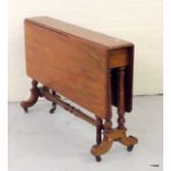 A mahogany Sutherland table on turned supports and Bakolite castors