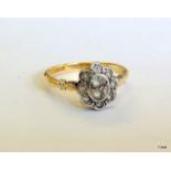 An Art Deco 18ct gold and platinum ring set with white sapphires