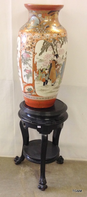 A 19th century Japanese Kutani vase on an ebonised wooden tripod stand (stand 56cm pot 63cm)