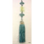 Chinese pale green Jade carving of a knot suspended in an intricate blue silk and tassel cord