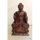 A carved wooden Buddha 83cm tall