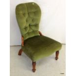 A green upholstered nursing/bedroom chair