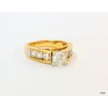 A 9ct yellow gold diamond ring with central stone 82points with diamond shoulders total weight