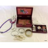 A jewellery box containing various items of jewellery  including silver