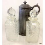 A pair of cut glass decanters and a tall pewter coffee pot