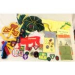 A quantity of vintage Boy Scout and Girl Guides memorabilia including badges - neckerchiefs -