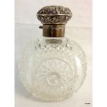 A silver scent bottle and stopper cut glass