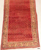 A Saroogh old runner repeated design in rusty red 302 x103