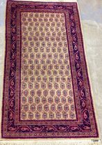 A small side carpet in pink and beige 135 x 72cm