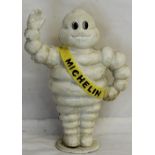 A figure of a Michelin Man waving