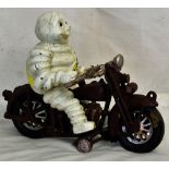 Figure of a Michelin Man riding a motorbike