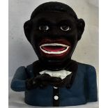 A novelty money box in the form of a man