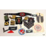 A selection of 20 assorted military cloth badges including a WW2 Postman's arm band