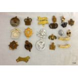 An assortment of 20 military badges including Essex Yeomanry - Army Dental Corps - Canadian Army