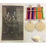 A mounted pair of WW2 medals and a silver identity tag engraved to 11555 Driver P Stuart of the