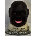 A novelty 'Smiling Sam' money bank