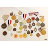 An assortment of 35 medals and medallions including military and football